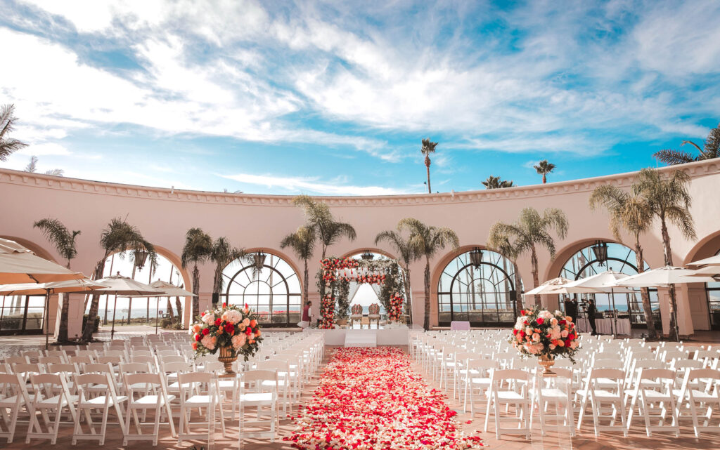 beautiful mandap for Indian wedding at Hilton Santa Barbara, Traditional Indian Wedding Mandap with Red flowers